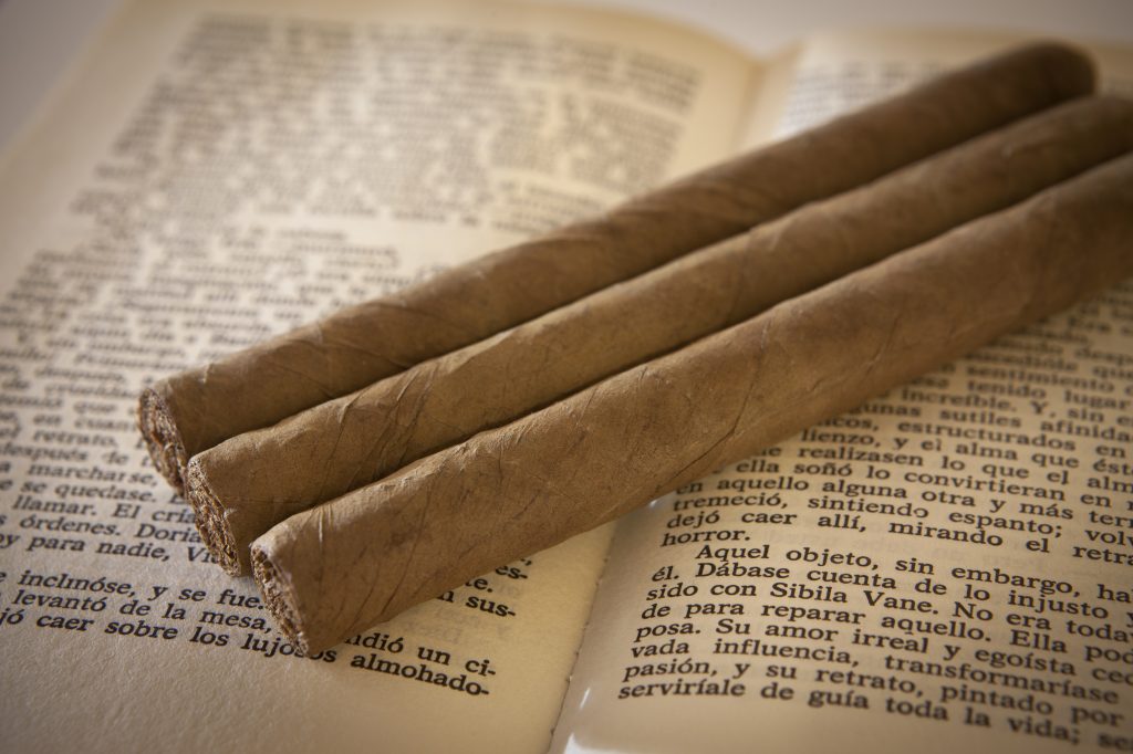 Cuban cigars over an open book
